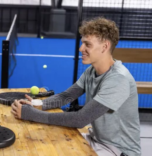 Player smiling courtside between padel games